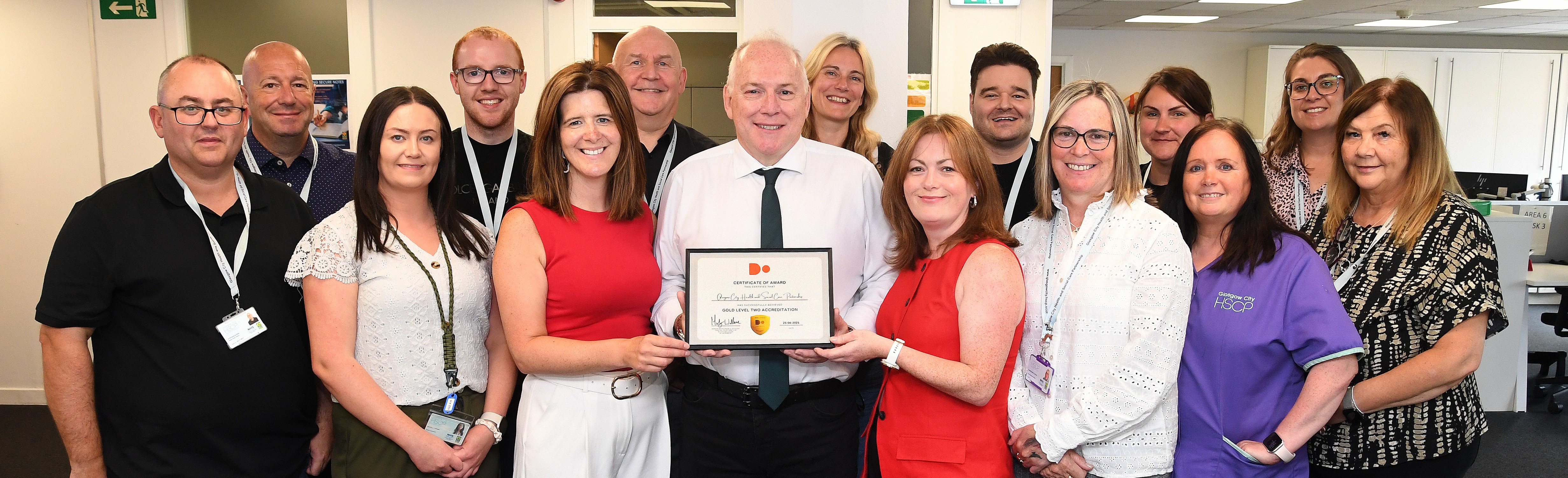 Image of staff holding Level 2 Certificate
