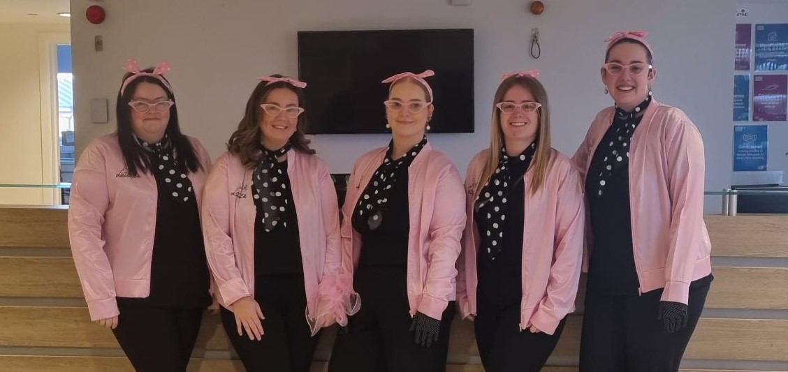 Image of five admin staff dressed as Pink Ladies