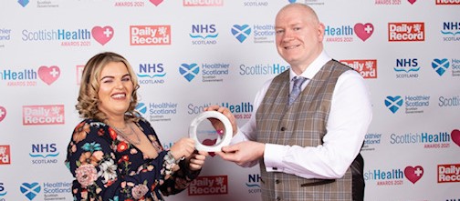 irsty Greig Admin Business Support Manager for Homeless Health (now Complex Needs) and Stewart Curtis, Nurse Team Leader for the Asylum Health Bridging Team acceptng People's Choice Award