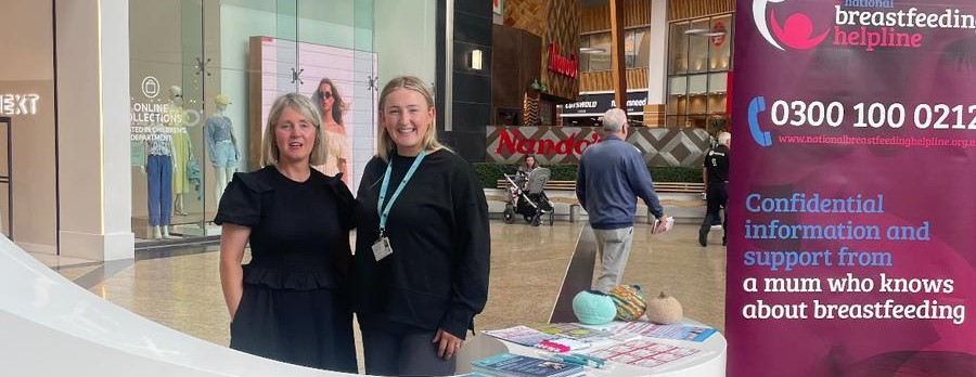 Staff with stall at silverburn supporting breastfeeding week.